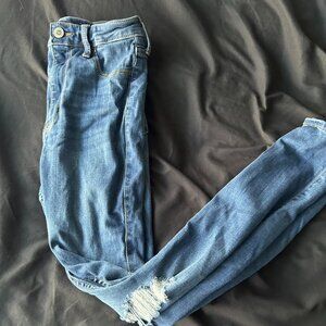 Women's blue high-waisted distressed denim leggings